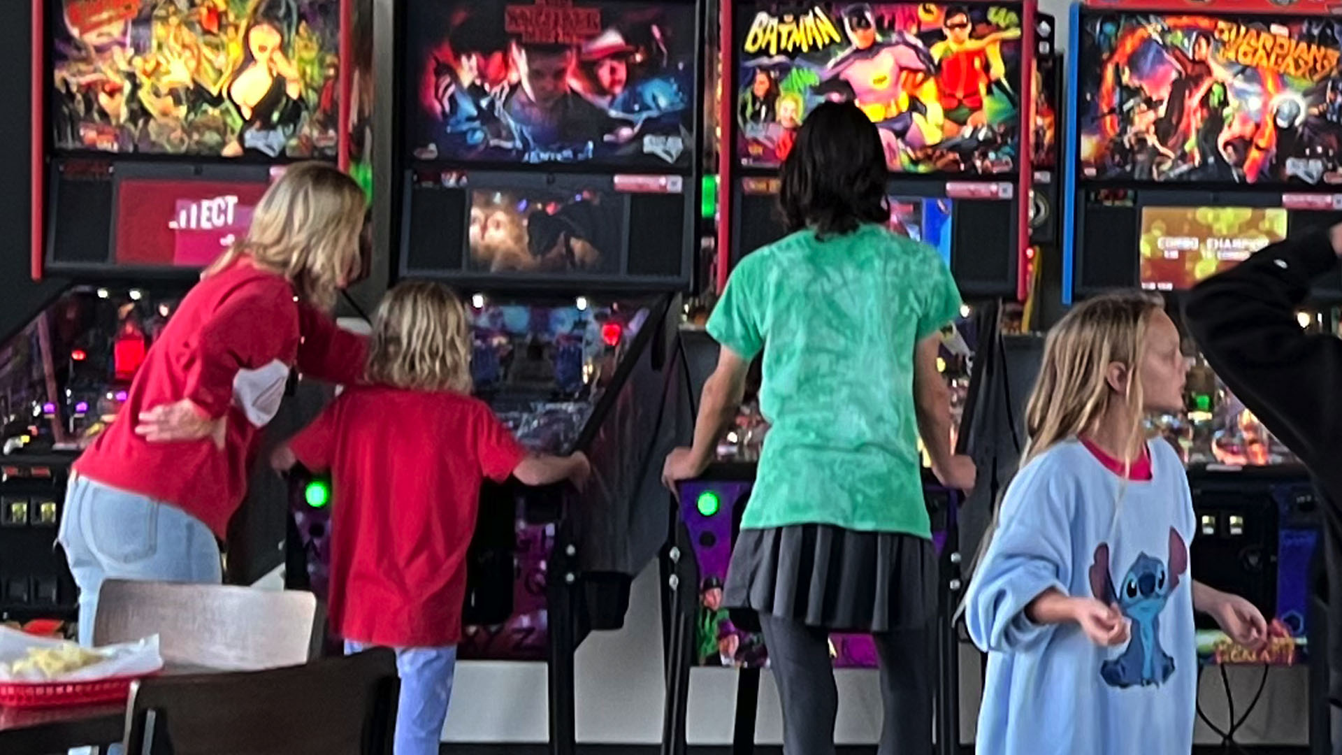 kids playing pinball