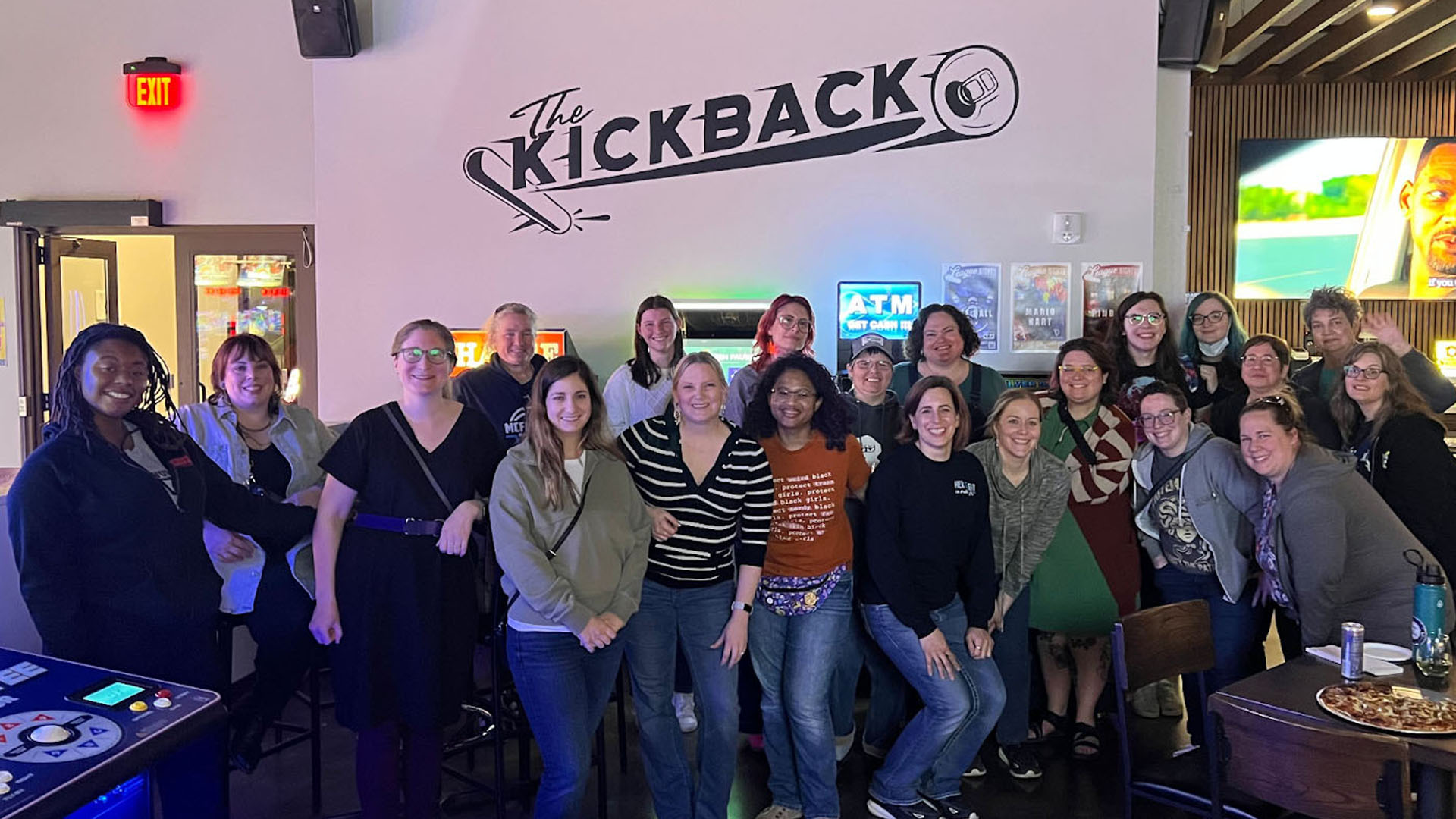 Belles and Chimes attendees in front of the Kickback sign