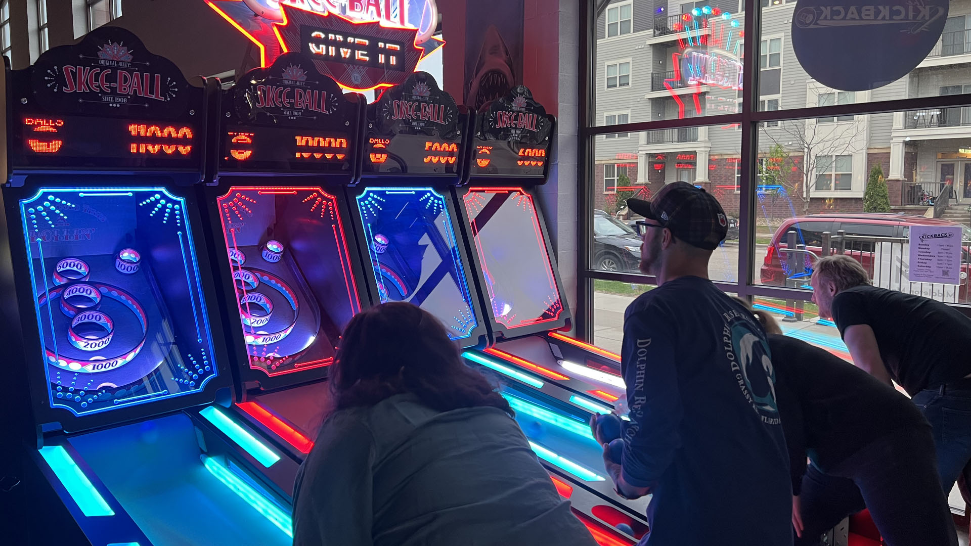 A group of people playing skeeball