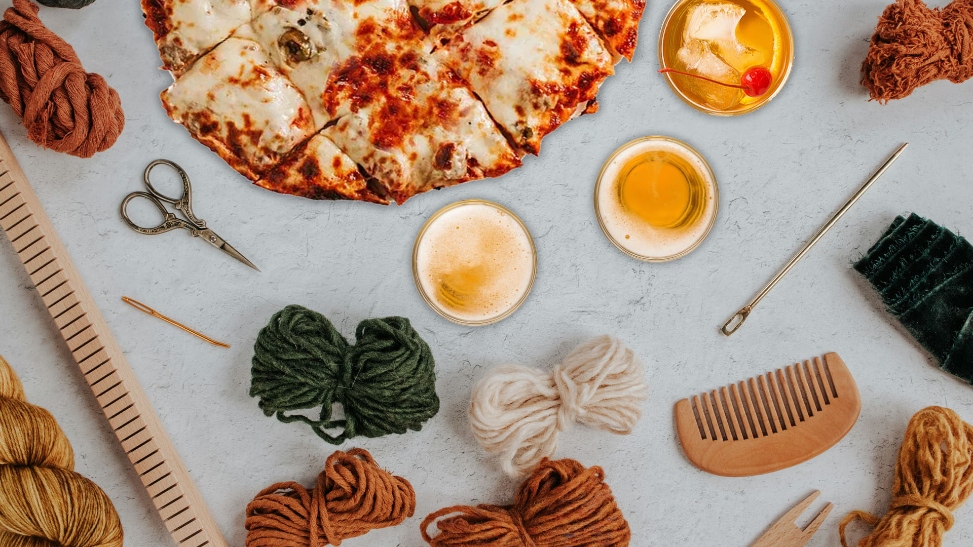 Craft supplies, beer and pizza all on a table