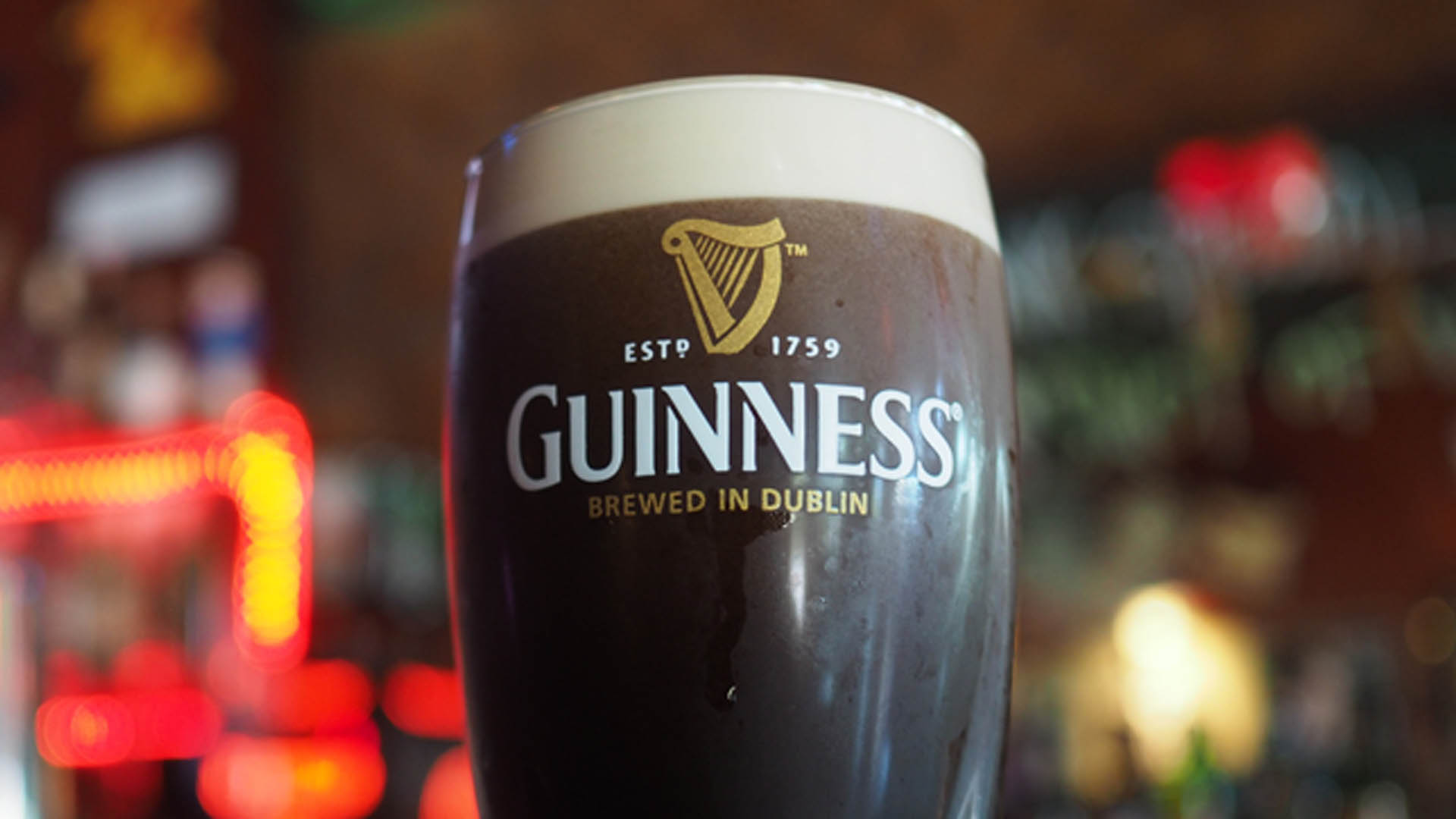 A glass of Guinness on a bar