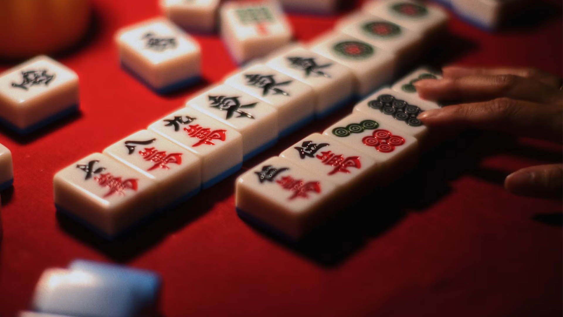 Mahjong tiles on a red table
