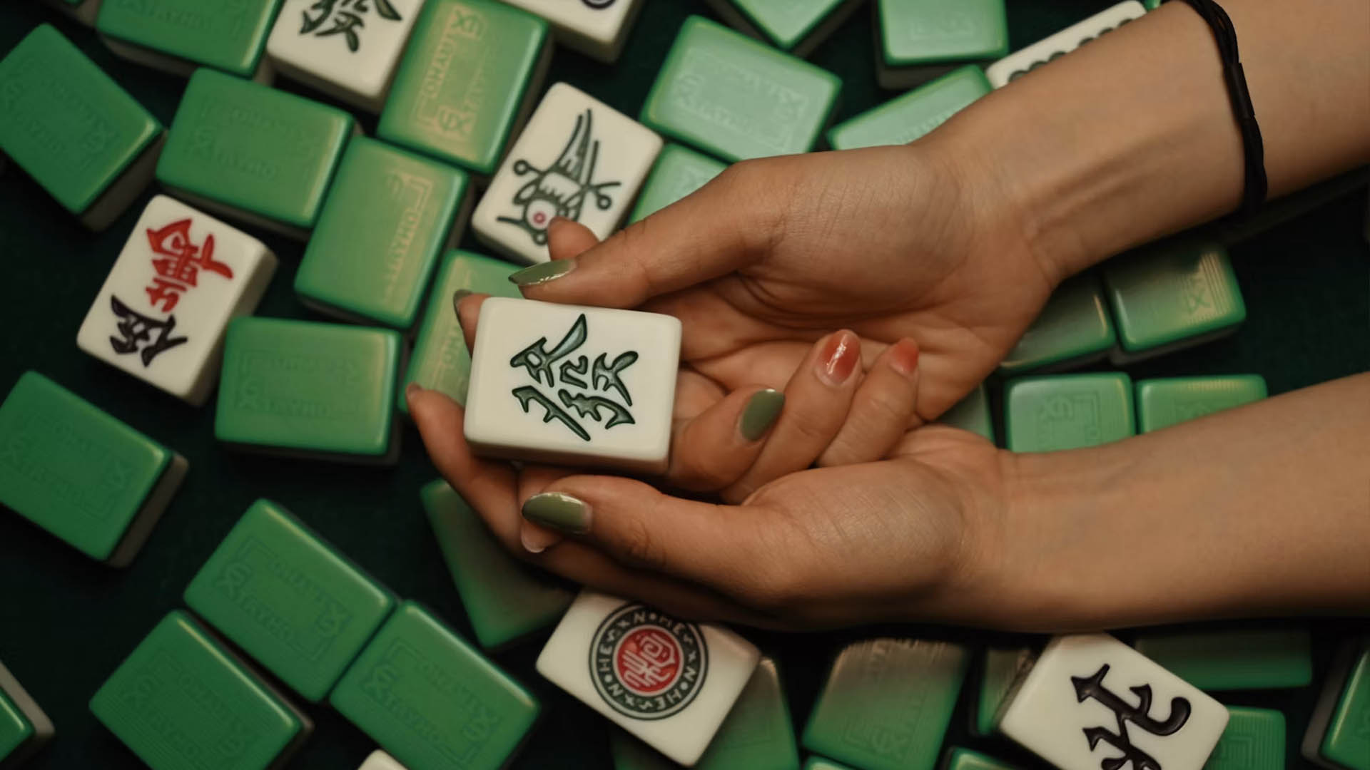 a person holding a mahjong tile