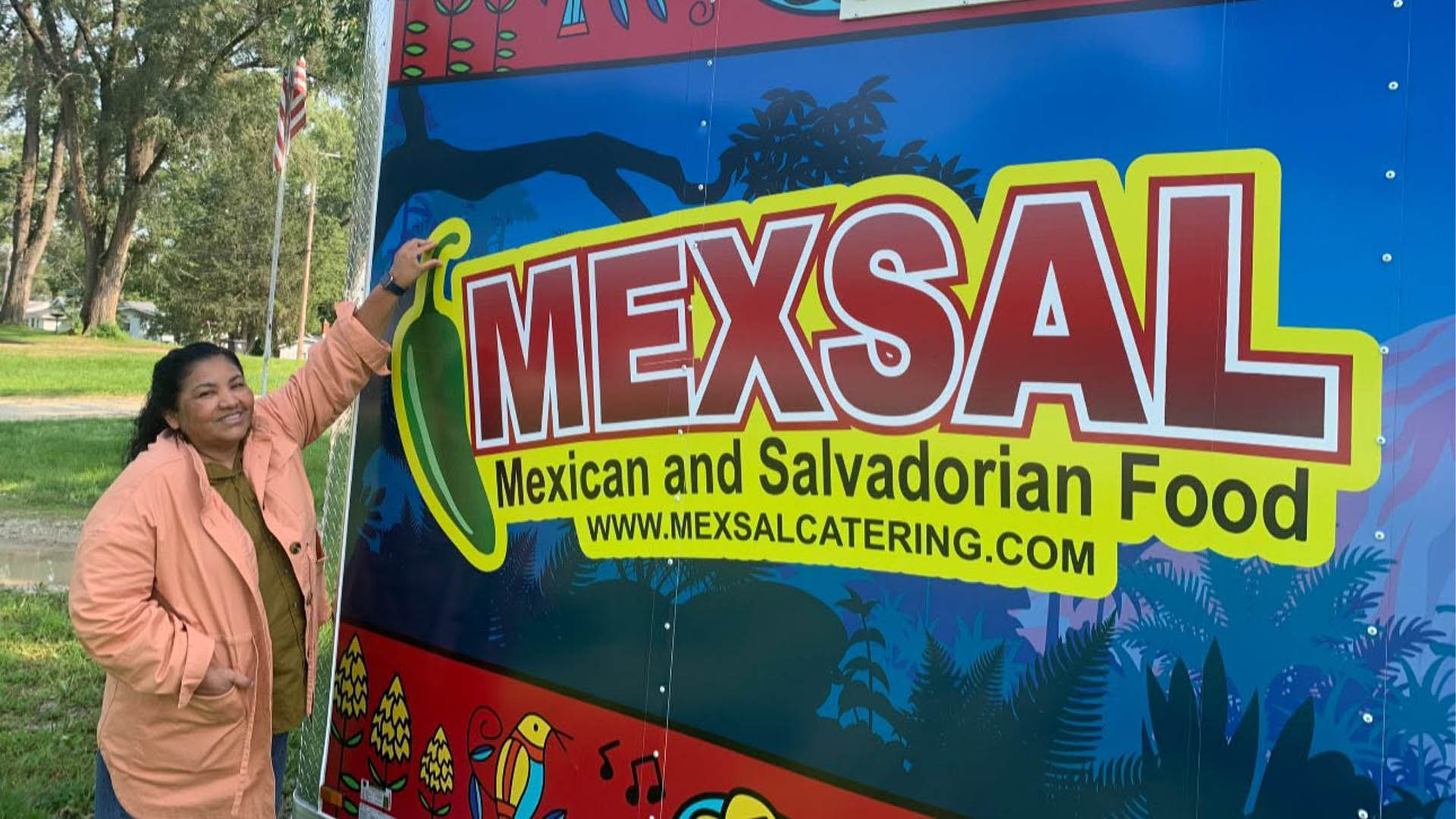 smiling person in front of the MexSal food truck
